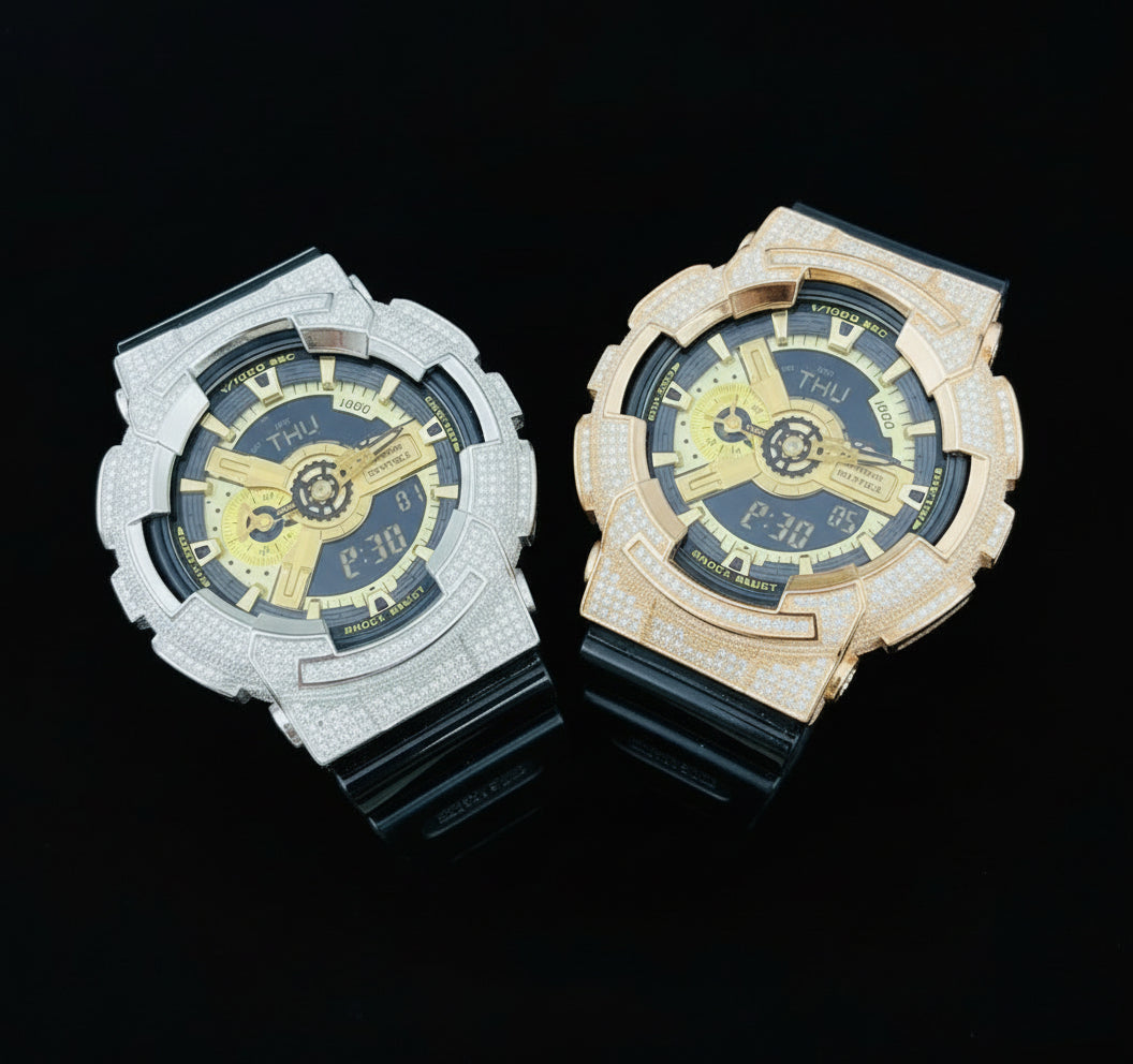 Two watches, one silver and one gold, on a black background